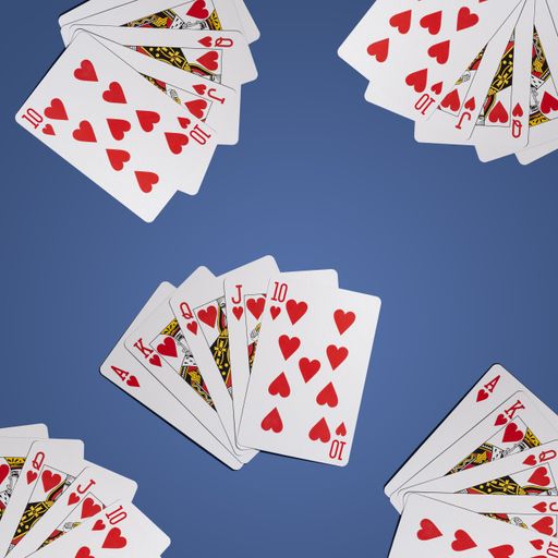 A flat lay shot of red playing cards on a blue surface