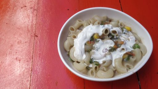 A high angle shot of a tasty looking pasta on a red table