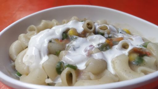 A high angle shot of a tasty looking pasta on a red table