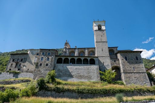 A low-angle shot of the old stony buildings against a blue sky