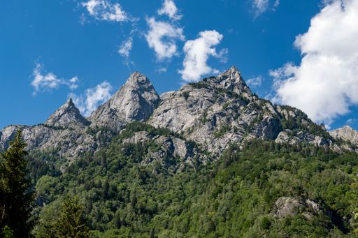 A landscape view of the rocky mountains against a blue sky