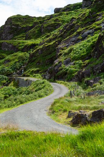 A beautiful shot of a pathway with a mountain around in Kerry in Ireland