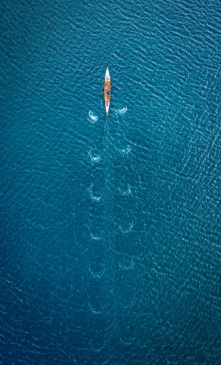 An aerial view of inrigger sailing in blue sea