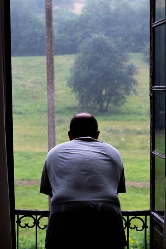 Man looks through the Window, Rain