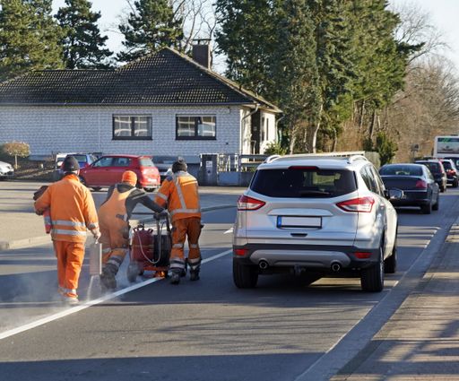 A back view of construction workers working on a street
