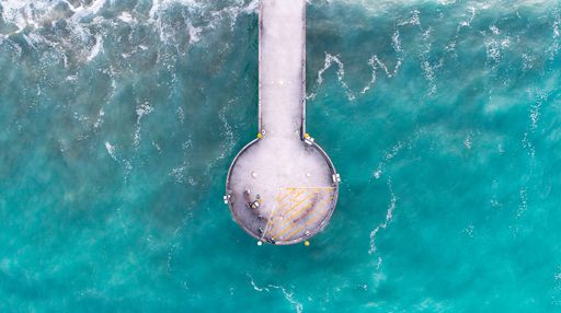 An aerial view of a pier over the sea