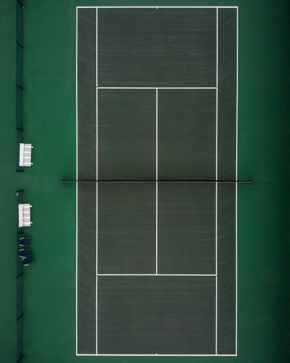 An aerial view of a green tennis court
