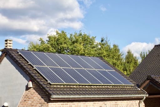A high angle shot of PV solar panels on the roof of a building