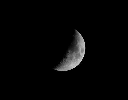 A beautiful shot of the half moon in the night sky