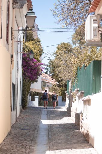 A vertical shot of tourists walking between buildings, Cascais, Portugal