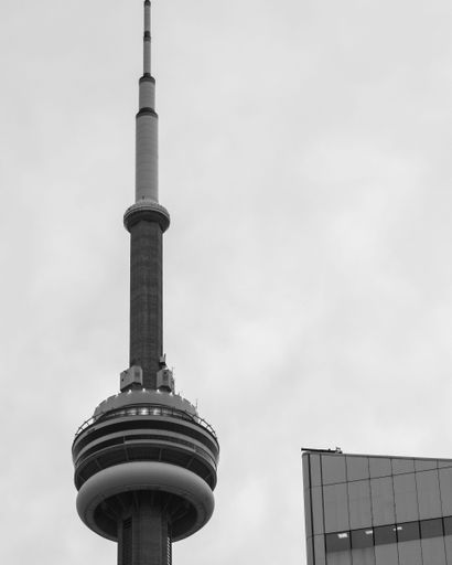 a grayscale of the top of CN Tower in downtown Toronto, Ontario, Canada