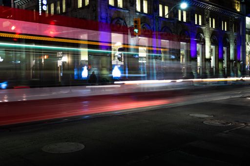 a light trail of a moving train at night in the street, long exposure