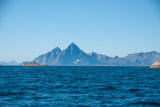 A beautiful view of the sea with mountains in the background in Lofoten Islands, Norway
