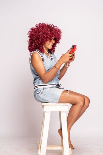 happy young black woman listening to music from her phone