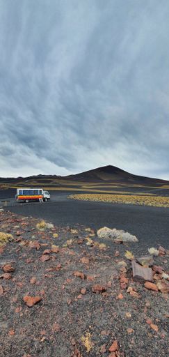A vertical low-angle of a tourist truck in the middle of the volcanic landscape of Timanfaya national park La Payunia, Mendoza, Argentina