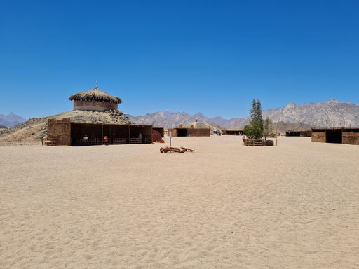 A beautiful shot of straw houses in a desert under a cloudless blue sky