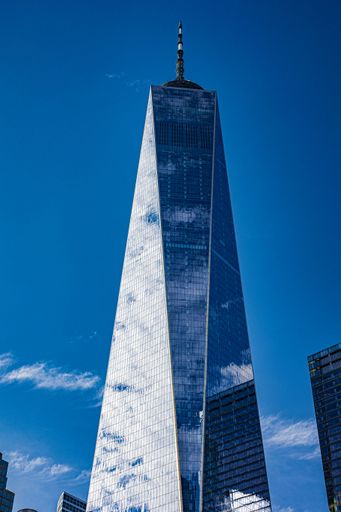 A vertical shot of Freedom Tower also known as One World Trade Center against the blue sky in Manhattan