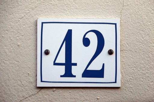 A closeup shot of the number sign of a house