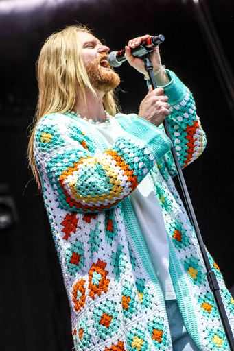 A vertical shot of the singer Sam Ryder during his performance at Hatfield House