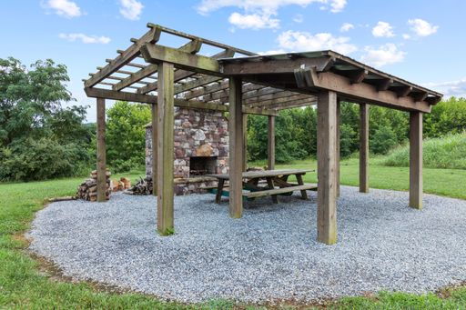 A beautiful shot of a firewood oven with a wooden structured pergola