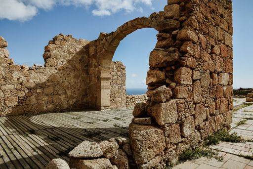 A beautiful shot of an archway from an abandoned and ruined building made of stone