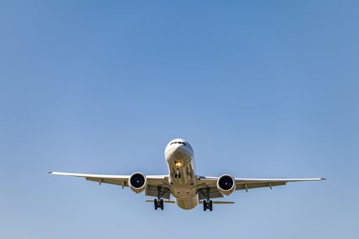 A low angle shot of an airplane flying closer at daytime