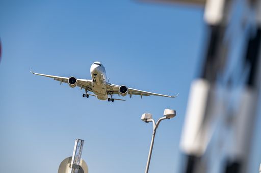 A low angle shot of an airplane flying closer at daytime