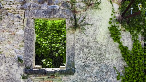 Italy 2020: Aerial view of an abandoned window in Faraone Vecchio. Nature, slowly, is embracing deteriorating constructions. July 2020, Abruzzo
