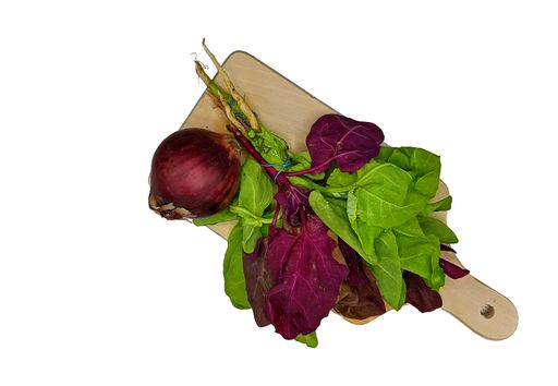 A top view of greens and a red onion on a wooden board isolated on a white background