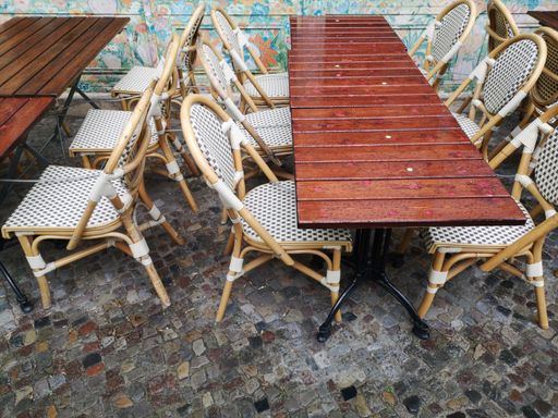 A high angle shot of tables with empty chairs at daytime