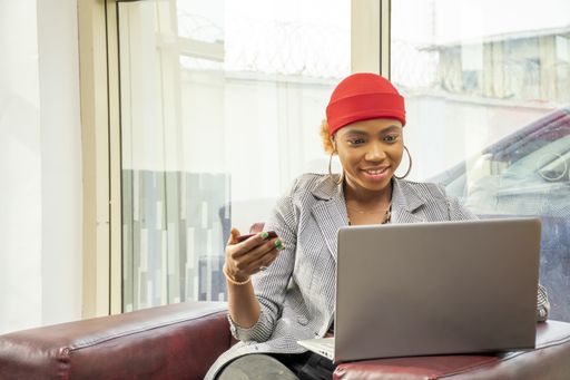 A pretty African businesswoman using her credit card and laptop