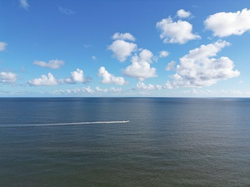 A boat sailing in the middle of the ocean