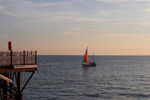 A sailboat on the sea with sunset background in Brighton, the UK