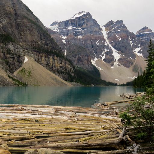 A breathtaking view of the Moraine lake surrounded by mountains on a cloudy day in Alberta, Canada