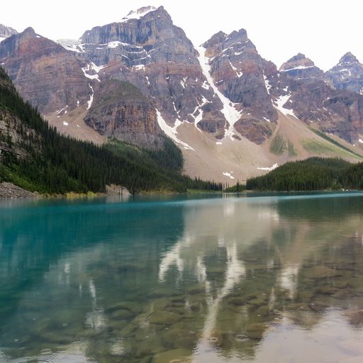 A breathtaking view of the Moraine lake surrounded by mountains on a cloudy day in Alberta, Canada