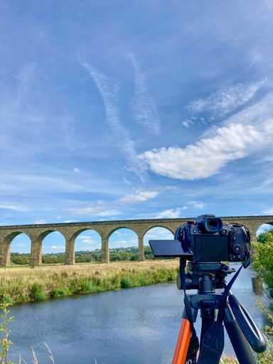 A vertical shot of Arthington Viaduct with a Panasonic Lumix S5 camera on a tripod in the foreground