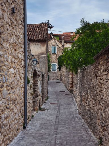 A vertical shot of an old narrow street in the small town of Skradin, Croatia