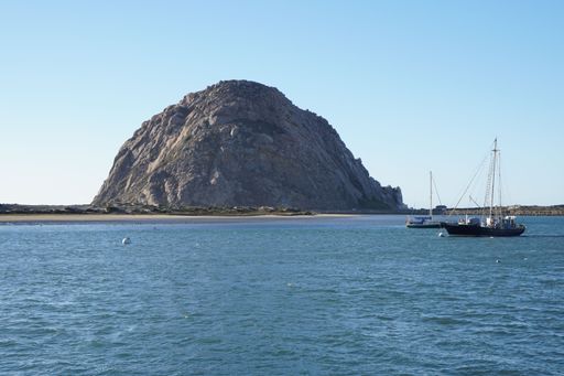 The Morro Rock in the background of the sea with sailboat, California