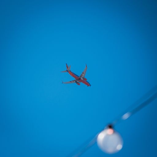 A low angle shot of Southwest Airlines plane flying over china town
