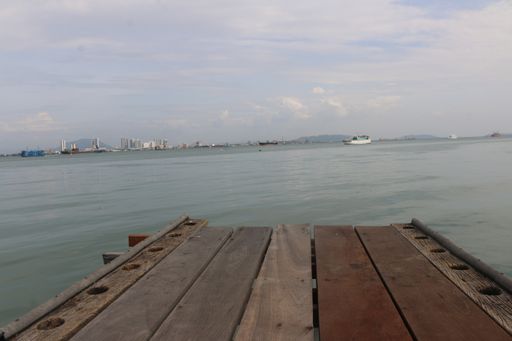 A beautiful wide shot of the sea from a pier in Penang Island, Malaysia