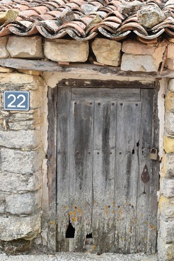 An old wooden door of a hut with the number 22 in Codes, Spain