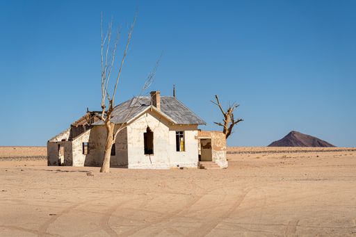 An old abandoned house in the middle of a forest in Garub Namibia on a sunny day under a blue sky