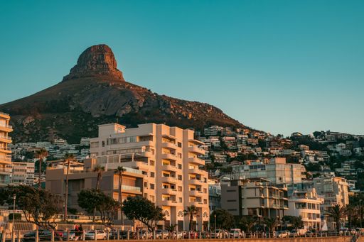 The buildings in Sea Point during sunset with the Lion's Head mountain peak in the background