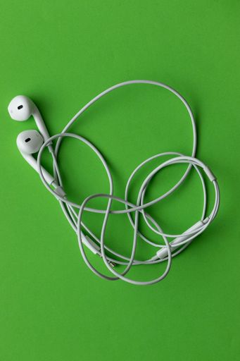 White headphones, on a green background
