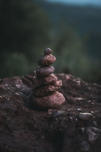 A vertical closeup shot of an arranged stack of brown rocks