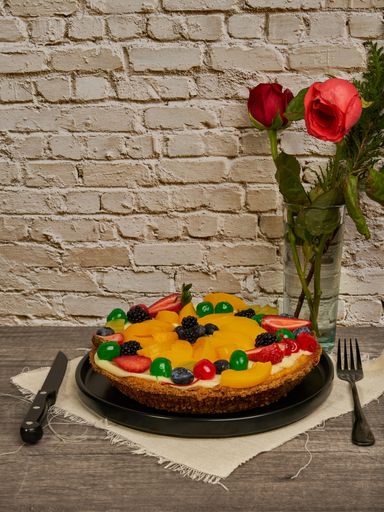fruitcake with strawberries, blueberries, cherries and peaches diner's eye view
