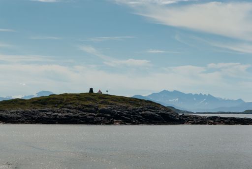 The distant lighthouse on the shore of Lofoten Island in Norway