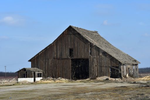 A landscape shot of an abandoned wooden farm