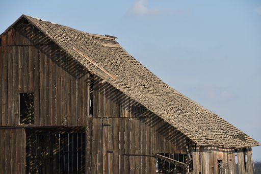 A landscape shot of an abandoned wooden farm