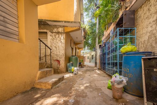 Santo Domingo, Dominican Republic; April 13, 2014: Corridor of Street Between Two Small Buildings